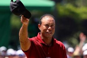 Tiger Woods acknowledges the crowd on the green on the 18th hole, after completing his final round.