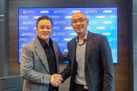Mr Ryan Gwee (left), founder and group chairman of Aleta Planet, and Mr Chin Mun Chung, CEO of AXS Services, signed a partnership agreement to launch remittance services through UnionPay. 