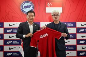 FAS president Bernard Tan (left) presenting a jersey to national coach Tsutomu Ogura during the latter&#039;s unveiling on Feb 1, 2024. 