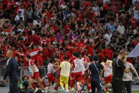 The Singapore football team celebrating in front of their fans after scoring the equaliser against China at the National Stadium on March 21.
