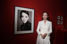 Singapore actress Fann Wong, next to a 2005 photo of her taken by Singaporean fashion and celebrity photographer Wee Khim, on April 4. She is featured in the exhibition Goddess: Brave. Bold. Beautiful. at Marina Bay Sands&#039; ArtScience Museum.