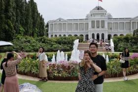Many visitors went on tours of the Istana grounds during a mostly sunny day.