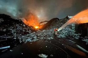 Firefighters battling a blaze at the premises of recycling and waste management company Wah and Hua on March 28, 2024.
