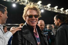 Singer Axl Rose (centre) attended the Las Vegas Formula One Grand Prix over the weekend, ahead of the complaint being lodged with a New York court.