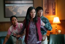 Michelle Yeoh (middle) starred in Everything Everywhere All At Once with Stephanie Hsu (left) and Ke Huy Quan.