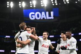 Harry Kane celebrates with teammates after scoring for Tottenham.