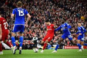 Liverpool's Hungarian midfielder Dominik Szoboszlai shoots and scores the second goal.