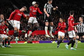 Manchester United's Marcus Rashford (centre) heading the ball as he defends the goal from a corner during the League Cup fourth round match between United and Newcastle at Old Trafford.