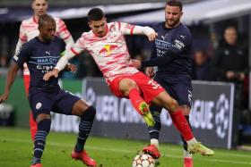Leipzig's Andre Silva (centre) is fouled by City's Kyle Walker (right), next to City midfielder Fernandinho.