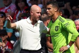 Manchester United manager Erik ten Hag (left) instructing substitute Cristiano Ronaldo during the match against Southampton on Aug 27, 2022.