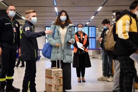 Passengers of a flight from China wait in a line for checking their Covid-19 vaccination documents as after arriving at the Paris-Charles-de-Gaulle airport on Jan 1.
