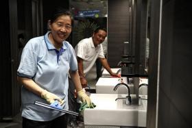 Cleaners Ms Li Xiu Mei (left) and Mr Yuen Kok Yeow hope that people will look after public toilets as if it were their own.