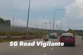 In a video posted on Facebook, a blue taxi is seen straddling the two leftmost lanes of the expressway before it knocked into the motorcycle.