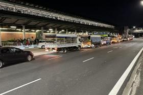 On average, 10 trucks would wait in line just before the public bus bay outside Kranji MRT station for the throngs of people who rush for a seat to return to their dorms.