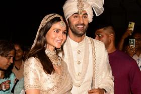 Bollywood stars Alia Bhatt and Ranbir Kapoor pose for pictures during their wedding ceremony in Mumbai.