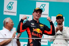 Red Bull&#039;s Max Verstappen celebrates after winning the last Malaysian Grand Prix in 2017.