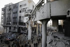 FILE PHOTO: Palestinians inspect the damages at Al Shifa Hospital after Israeli forces withdrew from the Hospital and the area around it following a two-week operation, amid the ongoing conflict between Israel and Hamas, in Gaza City April 1, 2024. REUTERS/Dawoud Abu Alkas/File Photo