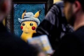 People look at paintings by artists inspired by the Pokemon at the Van Gogh museum in Amsterdam, on Sept 28.