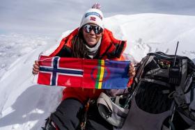 Norwegian climber Kristin Harila with her country flag at Shishapangma, the 14th-highest mountain in the world, in China.