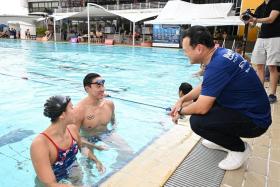Senior Minister of State for Defence and Safra president Zaqy Mohamad with national swimmers Quah Zheng Wen and Quah Ting Wen during the Safra Swim for Hope 2022.