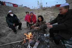 Shellshocked residents huddled around small fires in the street in quake-hit Dahejia, in north-west China’s Gansu province.