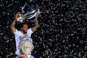 Real Madrid&#039;s Marcelo celebrates with the Champions League trophy in Madrid, a day after Real beat Liverpool in the final in Paris.