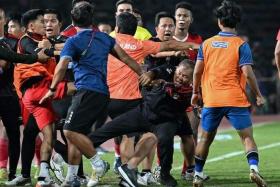 A fight breaks out on the sidelines of the men's football final match between Thailand and Indonesia during the SEA Games.
