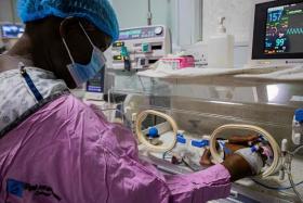 Ms Namukwaya checks on her twin babies inside an incubator at the Women's Hospital International and Fertility Centre.