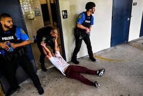 Children pose as victims with police officers, during an active shooter drill at a school in the US.