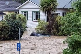 Car and homes submerged from the overflowing Maitai River in central Nelson, New Zealand's South Island, on Aug 17, 2022. 