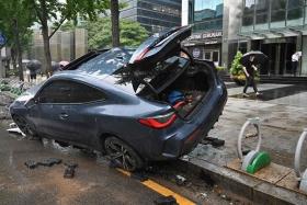 A car damaged by flood water is seen on the street after heavy rainfall at Gangnam district in Seoul, on Aug 9, 2022.  