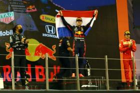 Formula One World Champion Max Verstappen of Red Bull celebrates on the podium after winning the Abu Dhabi Grand Prix on Dec 12, 2021.