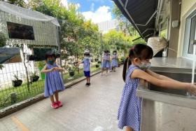 Pre-schoolers at Far Eastern Kindergarten queueing to wash their hands before snack time.