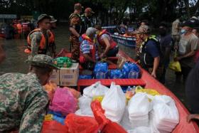 Members of the Malaysian military and emergency services prepare to deliver food to residents in Shah Alam on Dec 20, 2021.