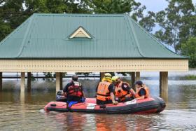 State Emergency Service volunteers using an inflatable boat for rescue operations in Camden, in south-western Sydney, on March 8, 2022. 