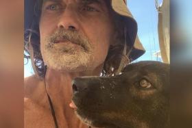 Mr Tim Shaddock and his dog Bella survived by drinking rainwater and snacking on raw fish.