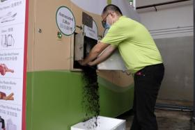 A-Smart Life engineer Lim Yuxin demonstrates the food waste treatment process in Tampines on April 9, 2022.