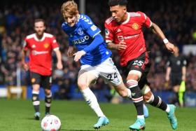 Everton&#039;s Anthony Gordon (left) vies with United&#039;s Jadon Sancho during their match at Goodison Park on April 9, 2022.