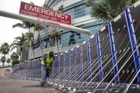 Workers install a flood barrier to secure Tampa General Hospital in anticipation of Hurricane Ian, on Sept 27, 2022.