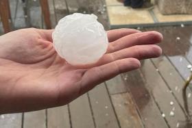 A person holding a hailstone during a hailstorm in Girona, Spain, on Aug 30, 2022. The girl was killed when a hailstone hit her on the head.