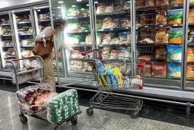 A woman shops for frozen food in a supermarket in Caracas, Venezuela, on July 7, 2022.