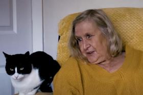 Zebby and his owner Genevieve Moss, who is deaf and lives alone in England. 