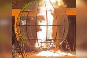 One of the riders appears to lose his grip on the cage’s walls and falls to the bottom of the globe. His bike then bursts into flames.