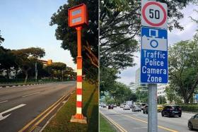 Red-light cameras are painted orange and white (left), and come with warning signs indicating that the area is a “Traffic Police Camera Zone”. 