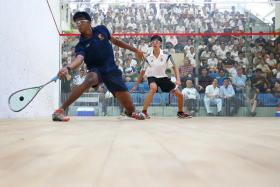 OFF TO A GOOD START: Nishan Ravi Nekoo (in blue) of ACS(I) setting the pace of their boys&#039; A Division squash final against RI&#039;s Sean Lim by winning the first game 11-8, 11-6 and 11-6.