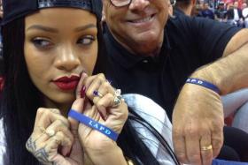 Rihanna and LAPD Commission President Steve Soboroff in a selfie taken at a basketball game on May 9, 2014, just before Rihanna dropped Soboroff&#039;s phone. 