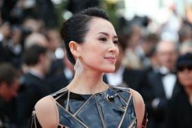 Chinese actress Zhang Ziyi poses as he arrives for the Opening ceremony of the 67th edition of the Cannes Film Festival in Cannes, southern France, on May 14, 2014.