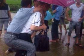 Mr Wang Junhua (on piggyback) lost his job after this photo went viral. Local authorities said the inappropriate act tarnished the image of party officials. PHOTO: 