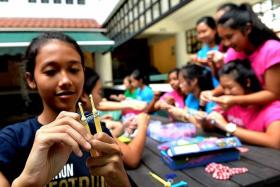 BIG HEARTS: (Above) Yamin Myint Soe and schoolmates from Raffles Girls&#039; School came up with the idea of selling Rainbow Loom bands for charity. 					 