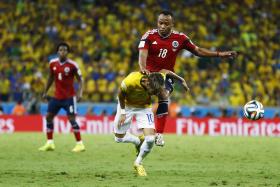 Brazil&#039;s Neymar (bottom) is fouled by Colombia&#039;s Camilo Zuniga during their 2014 World Cup quarter-finals at the Castelao arena in Fortaleza July 4, 2014. Photo: Reuters